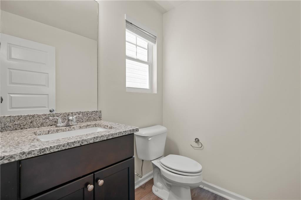 631 Carlton Pointe Drive, Unit 24 Palmetto, GA 30268 - Photo 16 of 20 a bathroom with a granite countertop sink toilet and mirror
