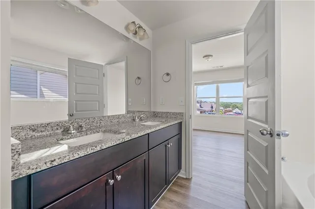 a bathroom with a granite countertop sink mirror and double