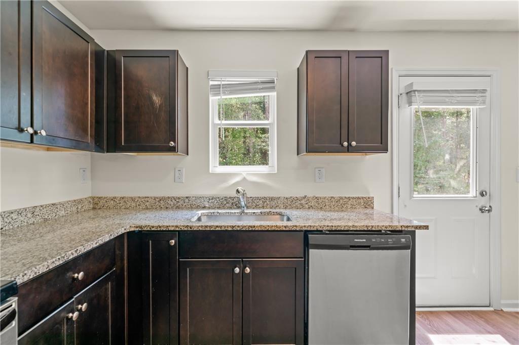 631 Carlton Pointe Drive, Unit 24 Palmetto, GA 30268 - Photo 3 of 20 a kitchen with granite countertop a sink stove and cabinets