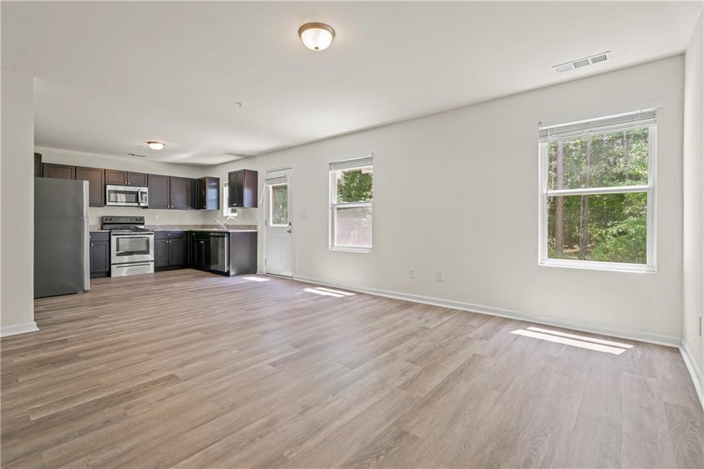 631 Carlton Pointe Drive, Unit 24 Palmetto, GA 30268 - Photo 7 of 20 a big room with windows and cabinet
