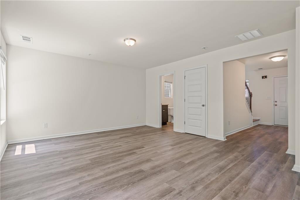 631 Carlton Pointe Drive, Unit 24 Palmetto, GA 30268 - Photo 8 of 20 a view of an empty room with wooden floor