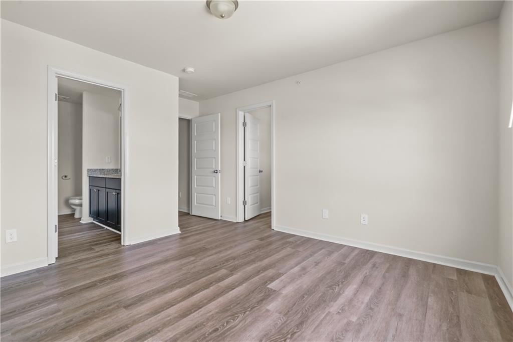 631 Carlton Pointe Drive, Unit 24 Palmetto, GA 30268 - Photo 9 of 20 a view of an empty room and wooden floor