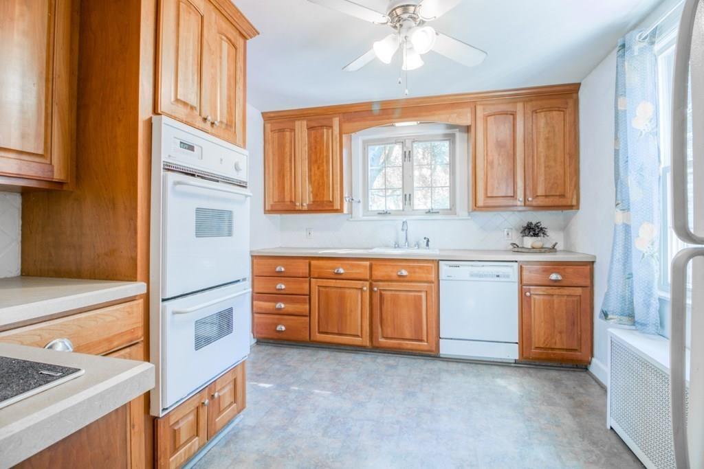 343 Plumtree Road Springfield, MA 01118 - Photo 6 of 27 a kitchen with granite countertop a sink cabinets stainless steel appliances and a window