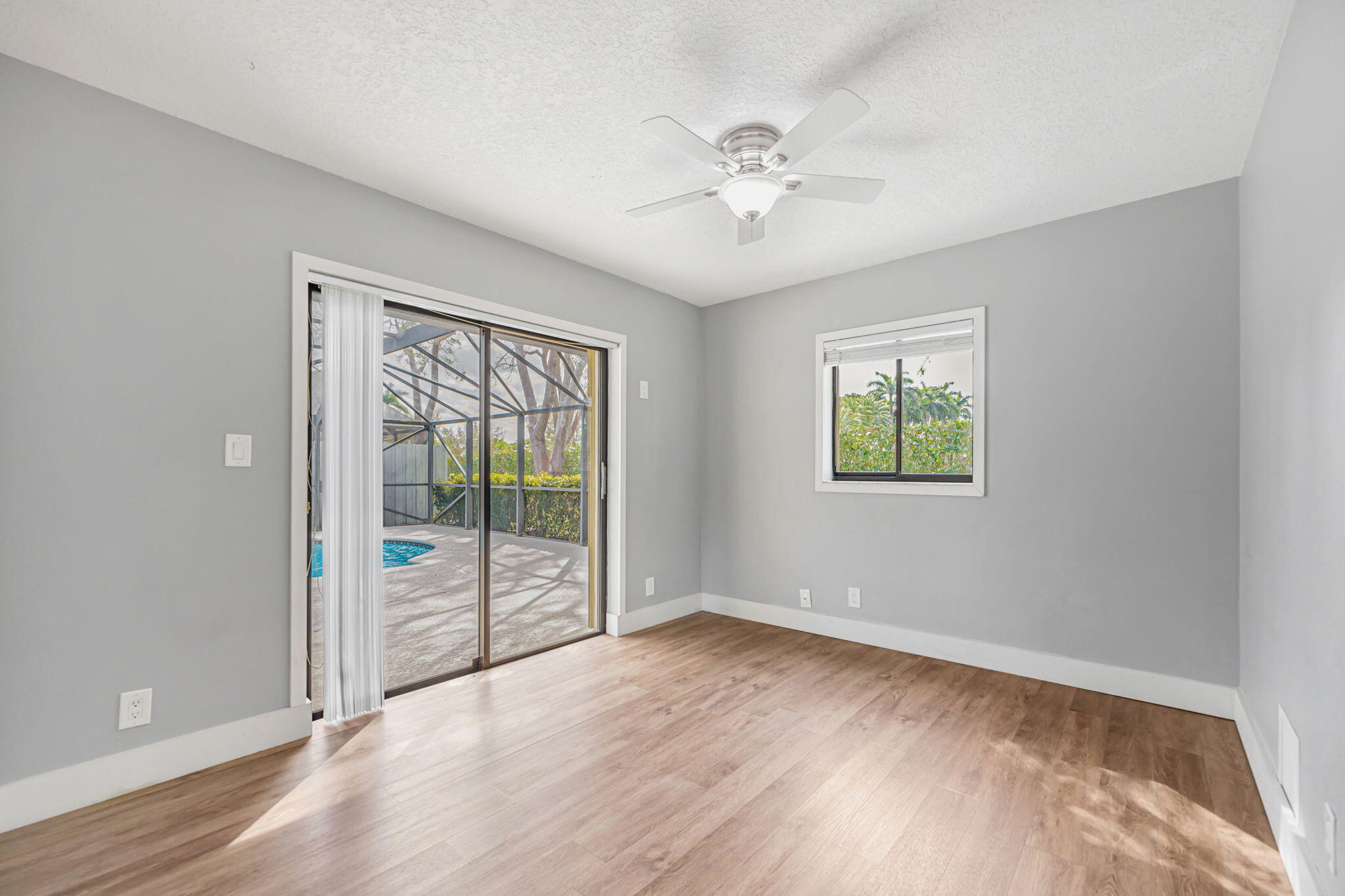 21356 Summertrace Circle Boca Raton, FL 33428 - Photo 15 of 33 an empty room with wooden floor fan and windows