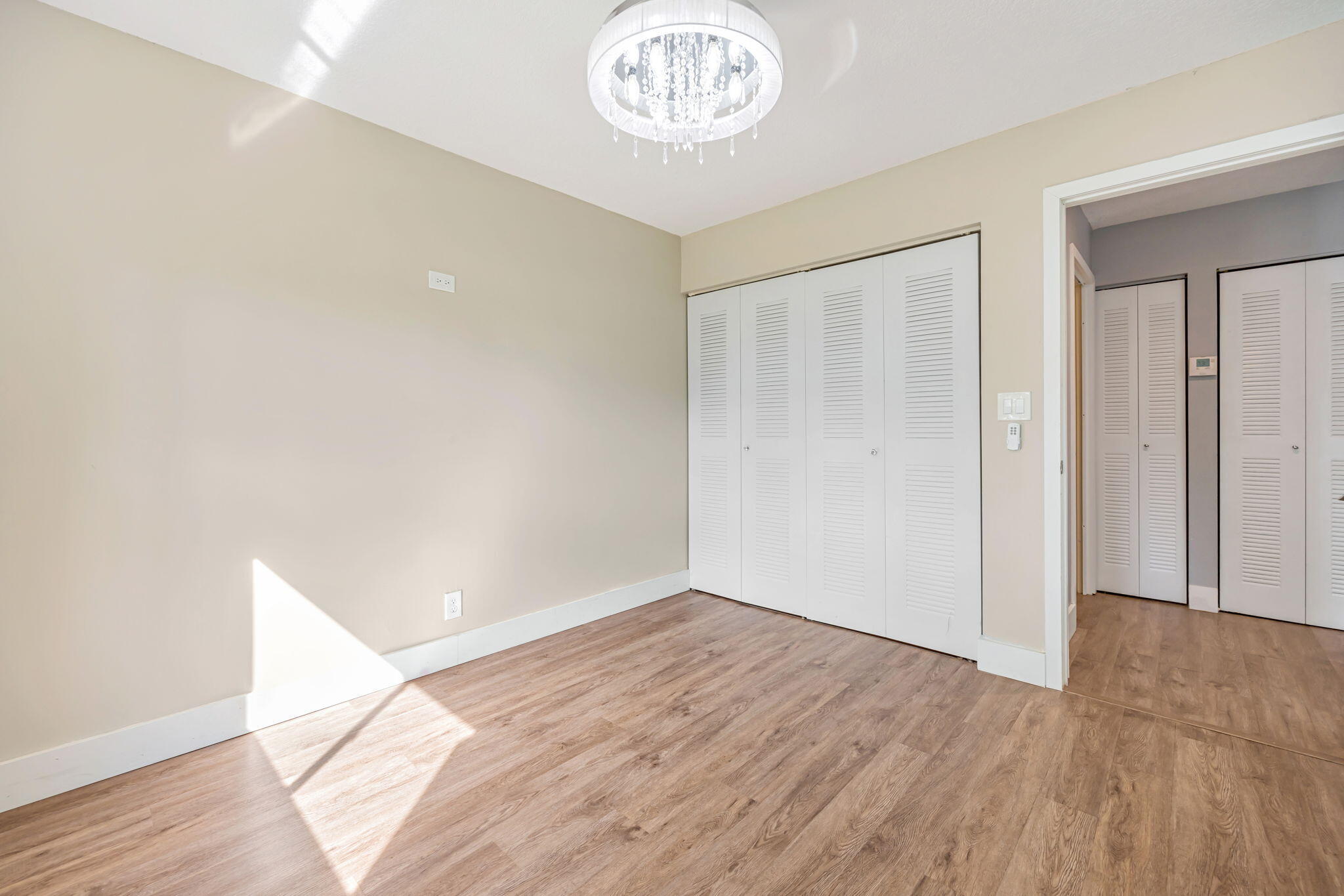 21356 Summertrace Circle Boca Raton, FL 33428 - Photo 19 of 33 an empty room with wooden floor and a white walls