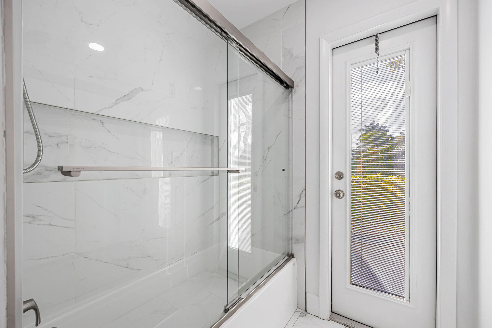 21356 Summertrace Circle Boca Raton, FL 33428 - Photo 27 of 33 a bathroom with a glass shower door