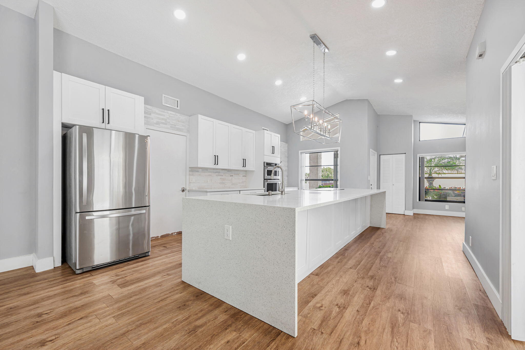 21356 Summertrace Circle Boca Raton, FL 33428 - Photo 4 of 33 a kitchen with a refrigerator a sink and wooden floor