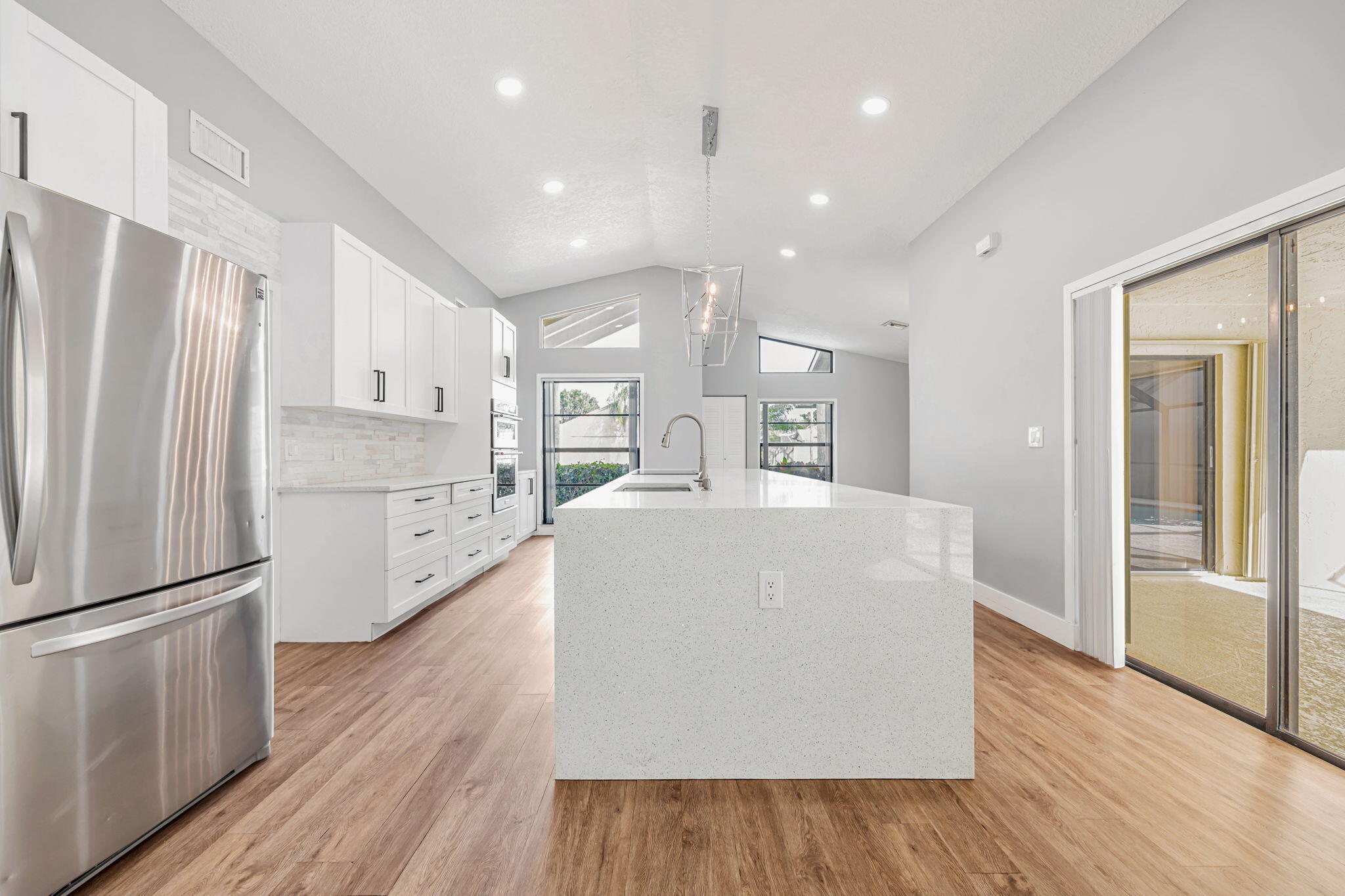 21356 Summertrace Circle Boca Raton, FL 33428 - Photo 5 of 33 a large white kitchen with wooden floor and a refrigerator