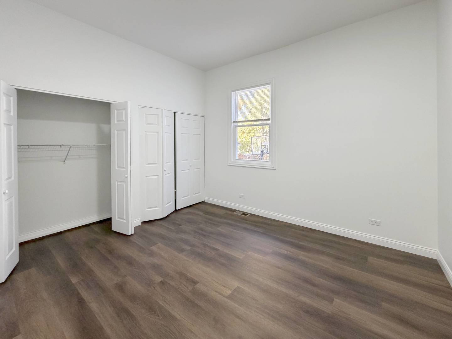 2982 South Lyman Street Chicago, IL 60608 - Photo 11 of 30 an empty room with wooden floor and window