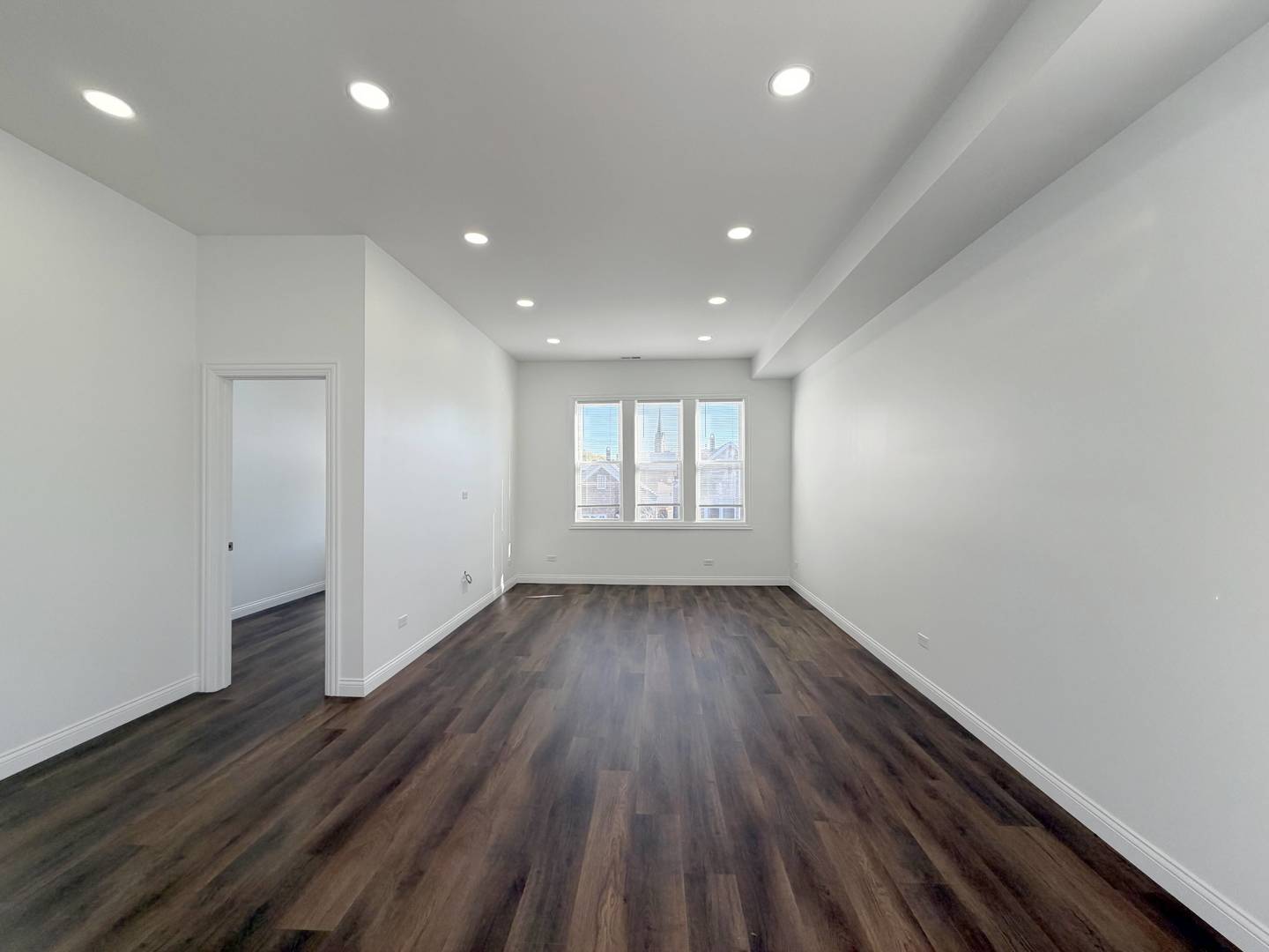 2982 South Lyman Street Chicago, IL 60608 - Photo 20 of 30 a view of an empty room with wooden floor and window