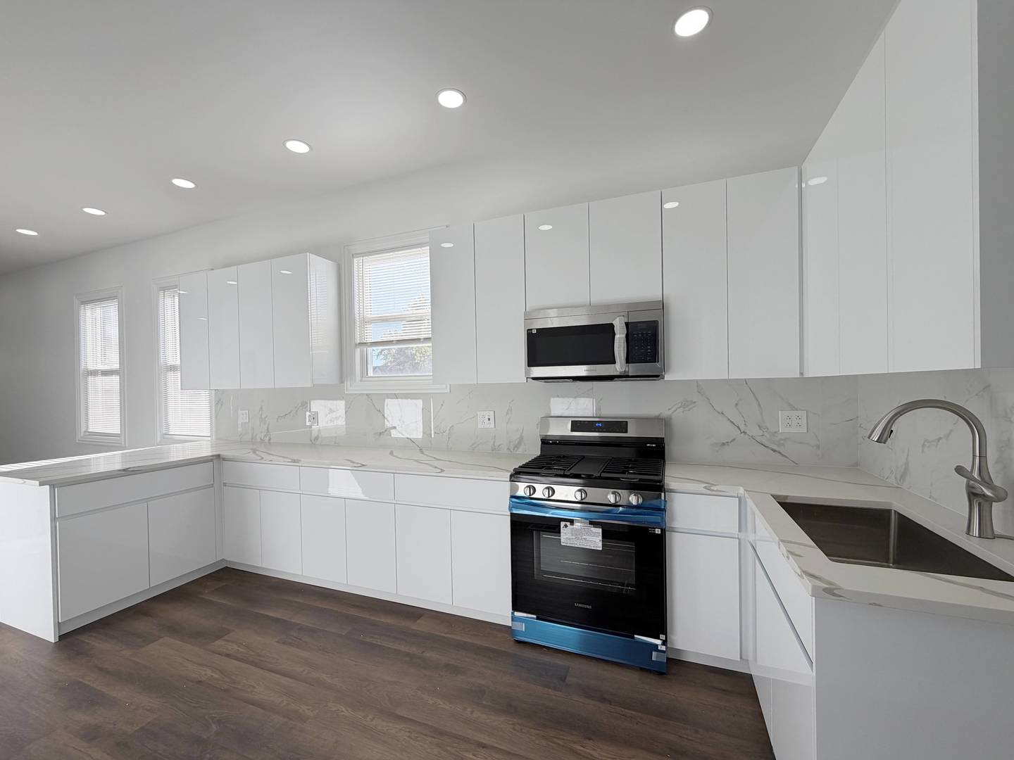 2982 South Lyman Street Chicago, IL 60608 - Photo 9 of 30 a kitchen with stainless steel appliances kitchen island granite countertop a stove and a sink