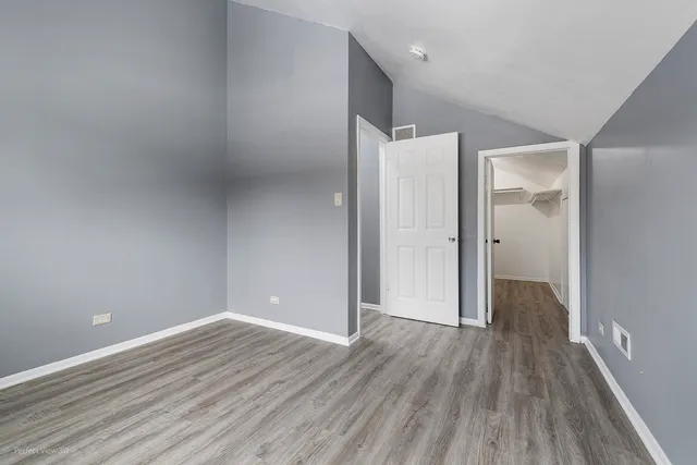 a bedroom with a bed and a lamp