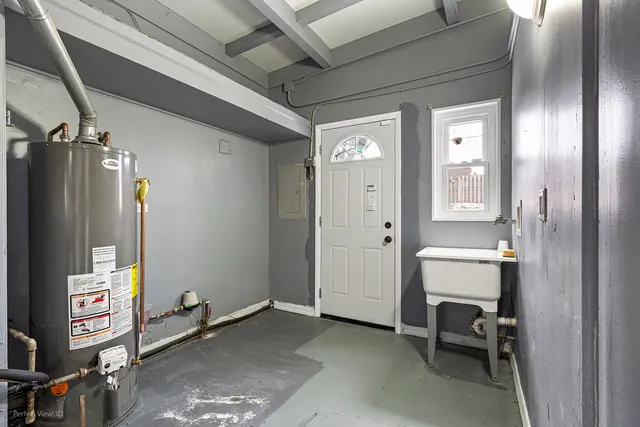 a view of an empty room with wooden floor and closet