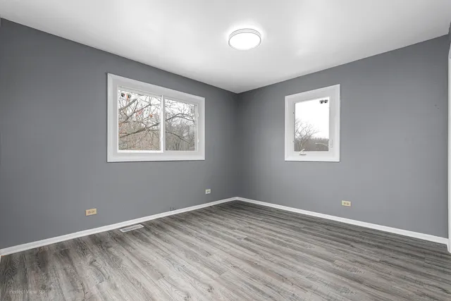 a view of room with window and wooden floor