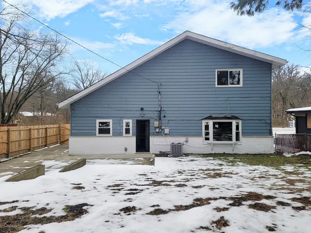 a view of a house with a yard covered in snow