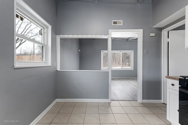 a kitchen with white cabinets and appliances