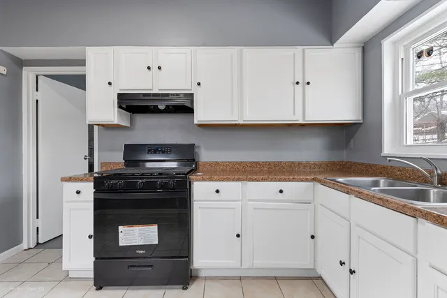 a kitchen with stainless steel appliances granite countertop a sink and a stove