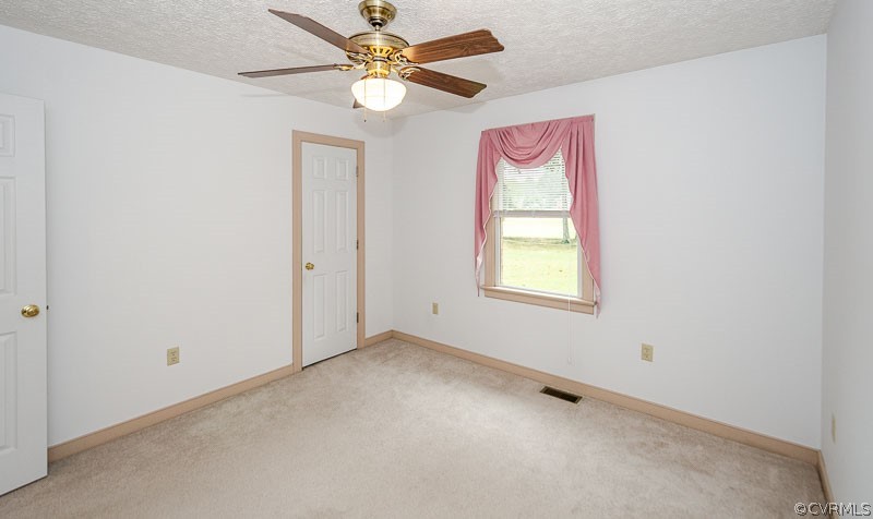 619 Broad St Road Manakin-Sabot, VA 23103 - Photo 32 of 49 an empty room with windows and fan