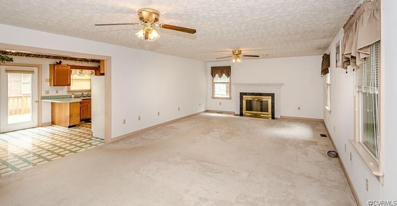 619 Broad St Road Manakin-Sabot, VA 23103 - Photo 9 of 49 a view of a livingroom with a fireplace a ceiling fan and windows