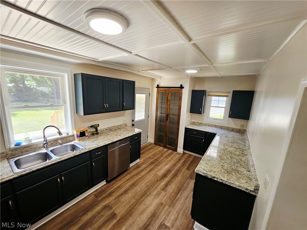 753 West River Road North Elyria, OH 44035 - Photo 6 of 28 Kitchen featuring wood-finish flooring, dark cabinetry, and light-toned countertops