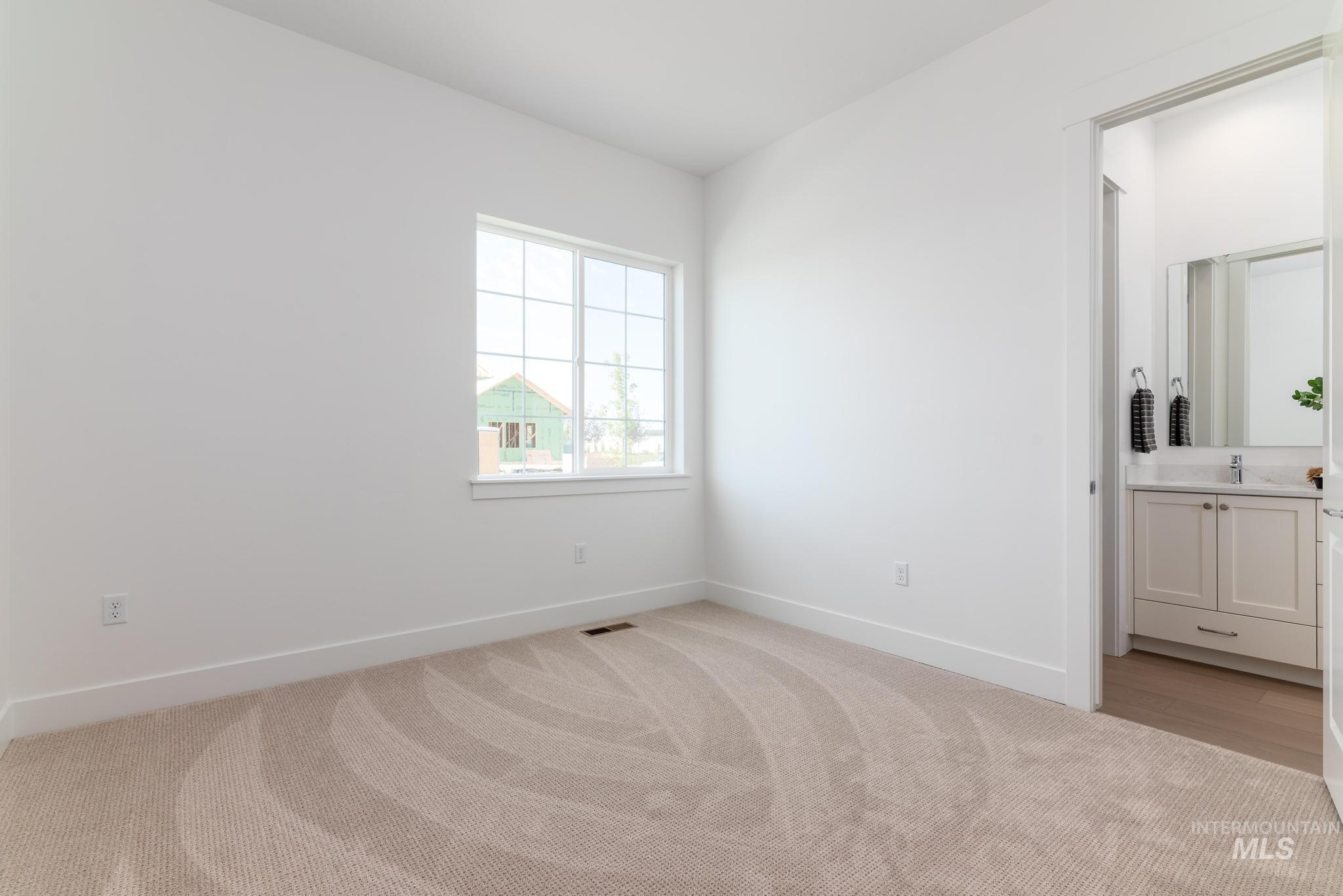 8558 South Silver Smog Way Meridian, ID 83642 - Photo 24 of 41 Bright interior space featuring light-toned walls and neutral patterned carpeting
