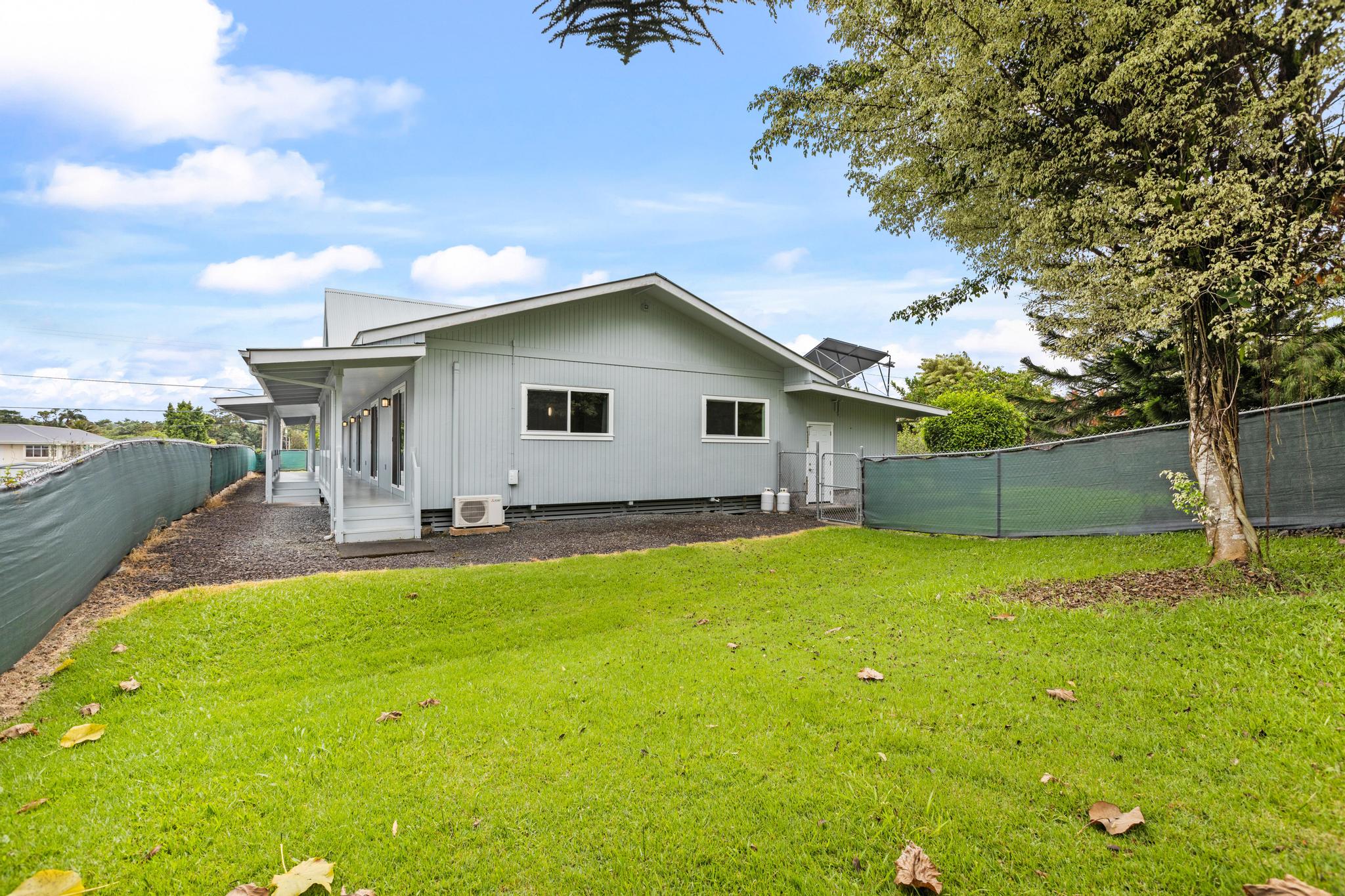 234 Kipa Street Hilo, HI 96720 - Photo 27 of 30 a backyard of a house with table and chairs