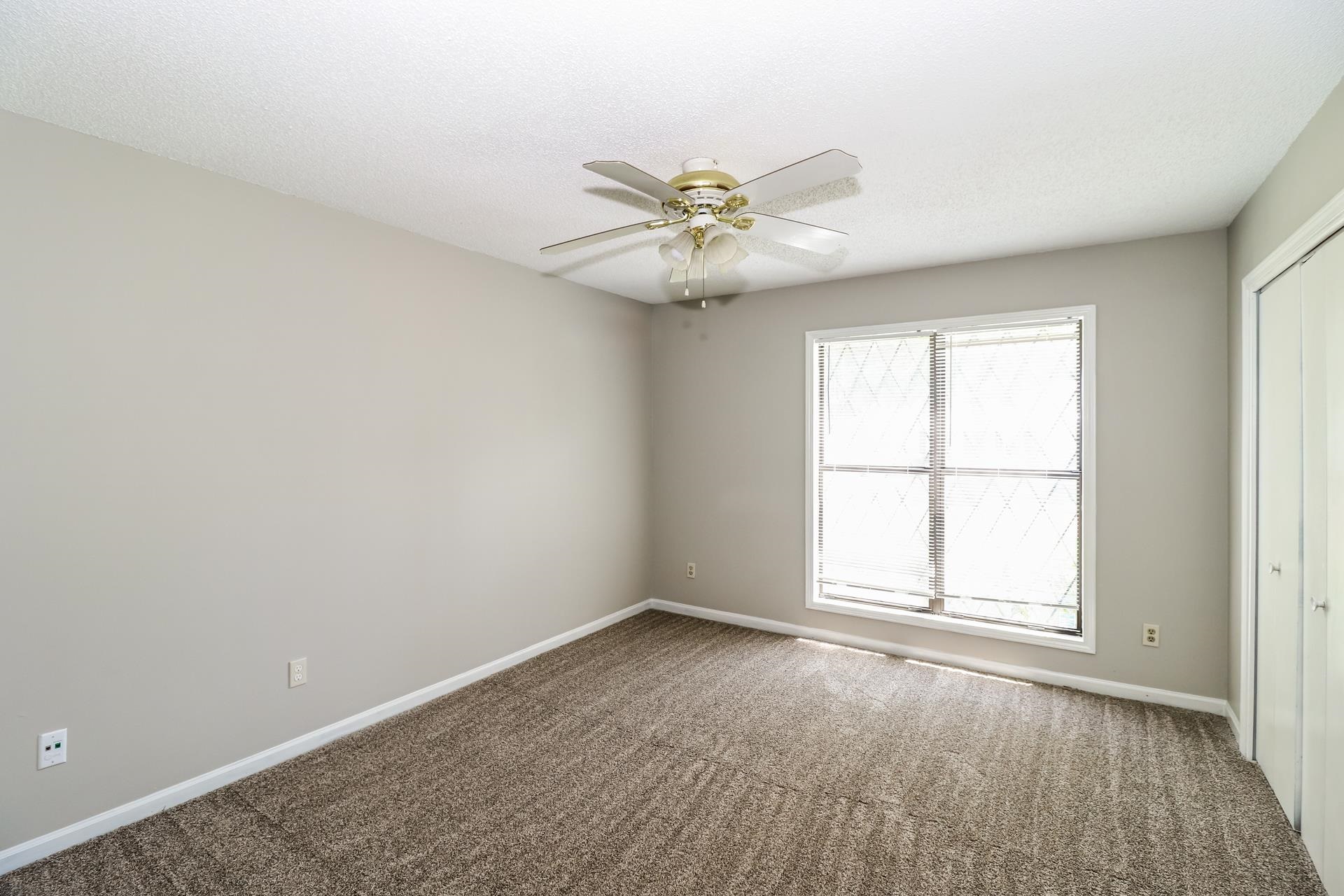 4475 Window Drive Memphis, TN 38135 - Photo 11 of 16 Unfurnished bedroom featuring a closet, carpet, and a ceiling fan