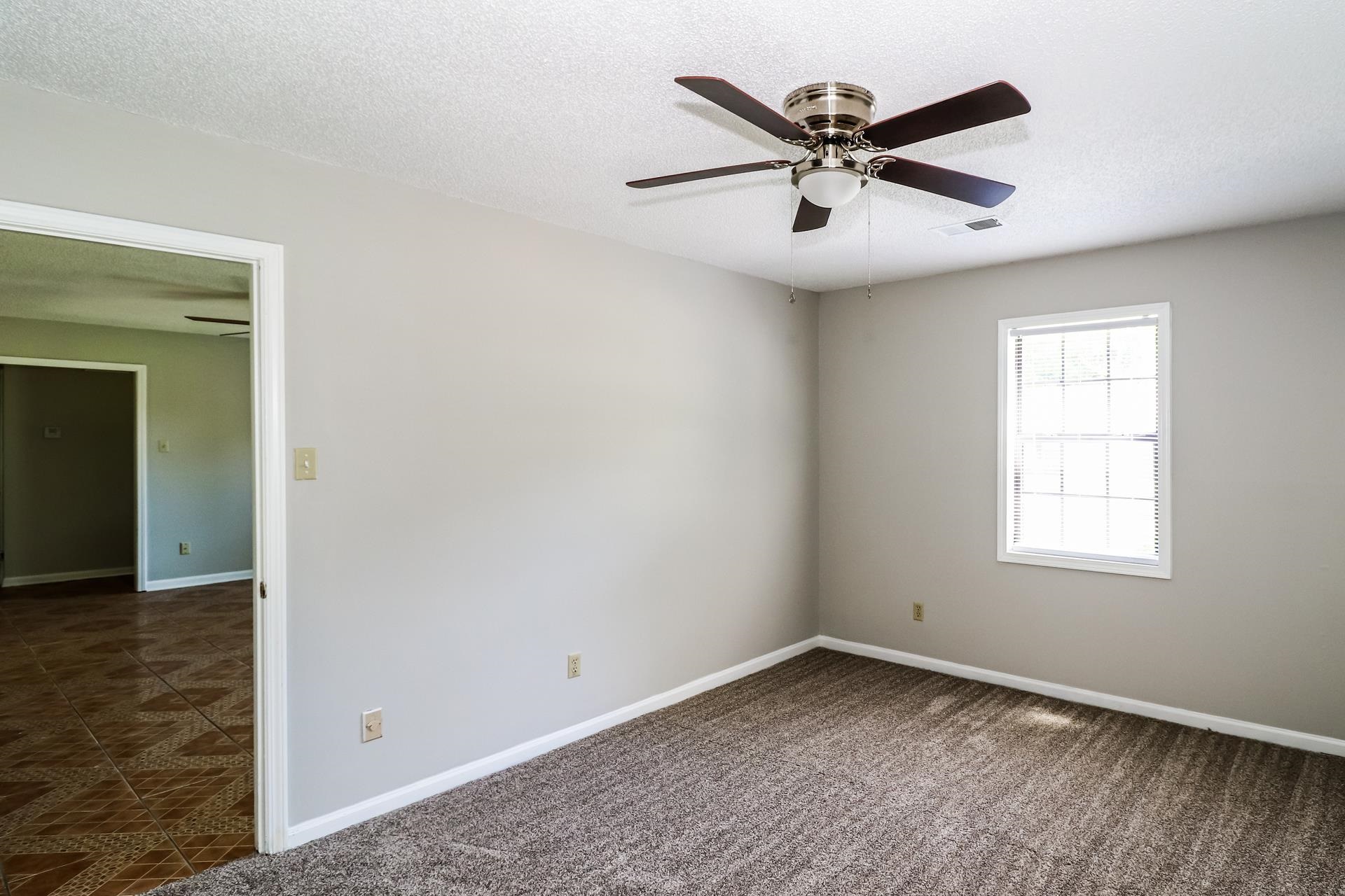 4475 Window Drive Memphis, TN 38135 - Photo 15 of 16 Spare room with ceiling fan, a textured ceiling, and dark carpet