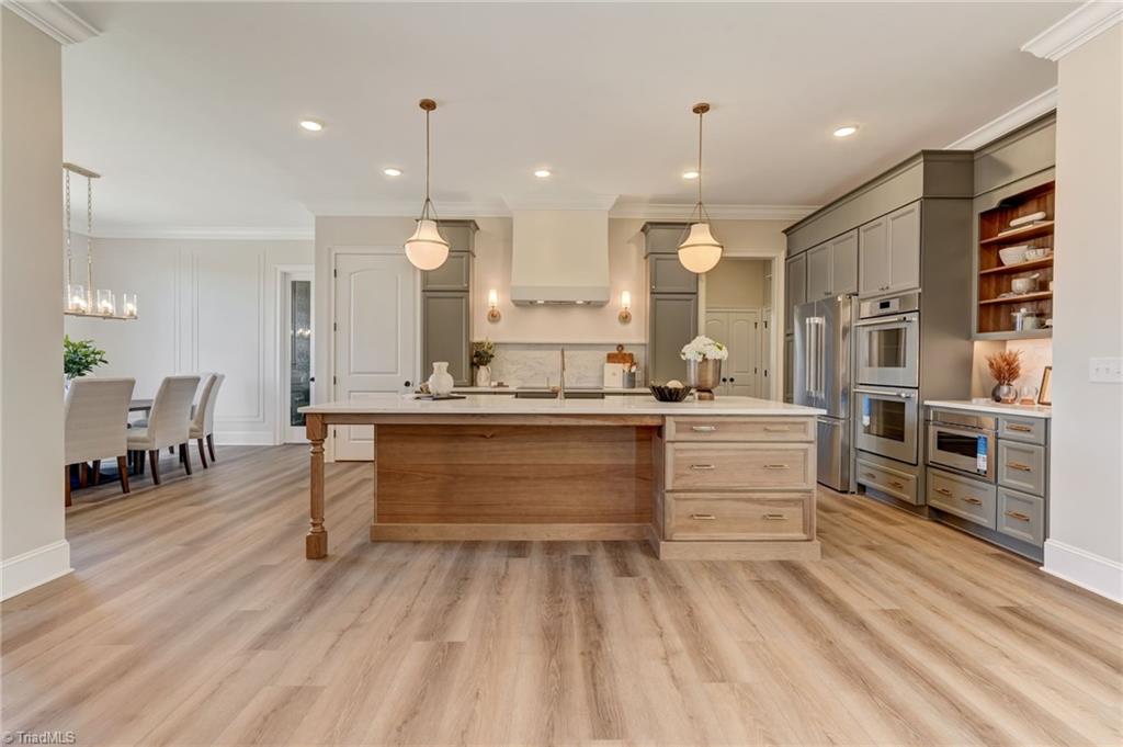 6806 Brennan Way Oak Ridge, NC 27310 - Photo 11 of 50 direct kitchen view, this island is exceptional - ample barstool seating opportunities and take note of the additional drawers on this side of the island!