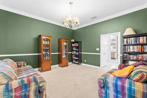 a bedroom with a bed and a flat tv screen on dresser