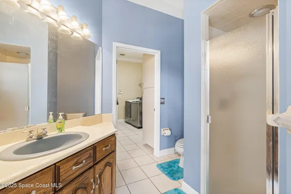 a spacious bathroom with a granite countertop sink a mirror and a