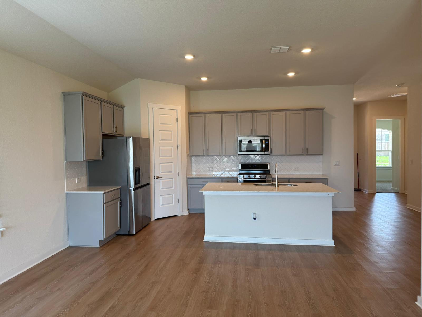 2037 Saddlery Street Leander, TX 78641 - Photo 20 of 38 a kitchen with stainless steel appliances granite countertop a refrigerator stove top oven and sink