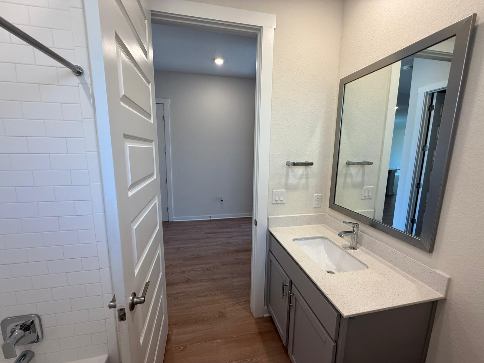 2037 Saddlery Street Leander, TX 78641 - Photo 36 of 38 a bathroom with a sink a mirror and a shower