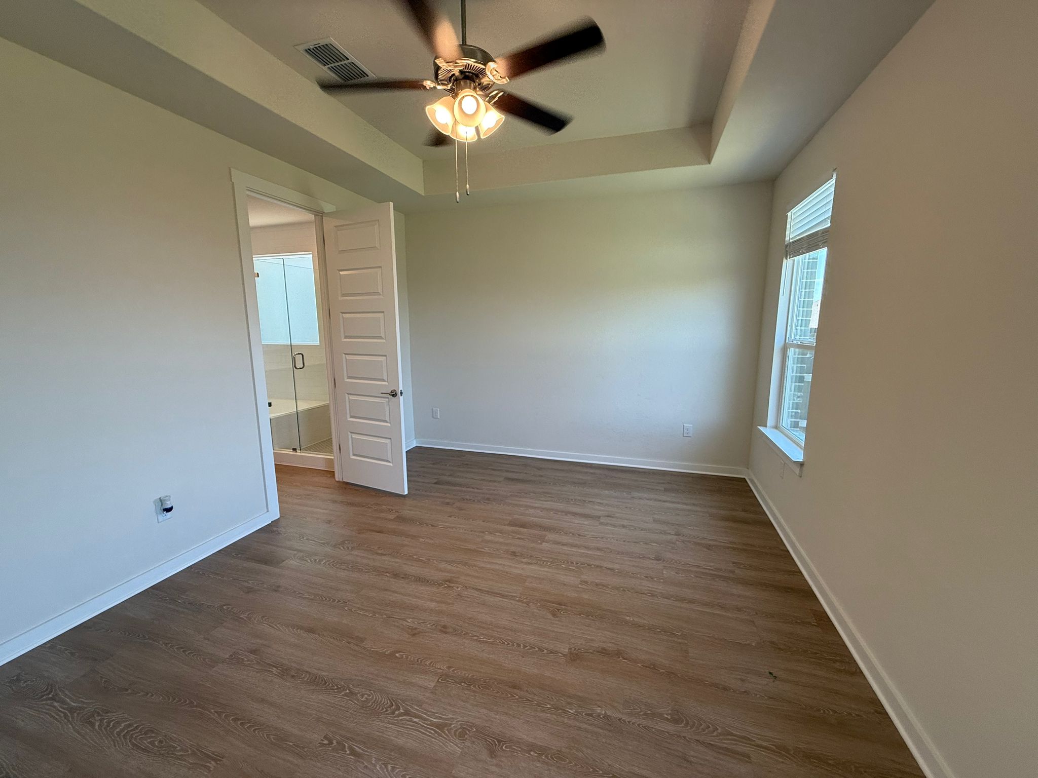 2037 Saddlery Street Leander, TX 78641 - Photo 6 of 38 an empty room with wooden floor chandelier fan and windows