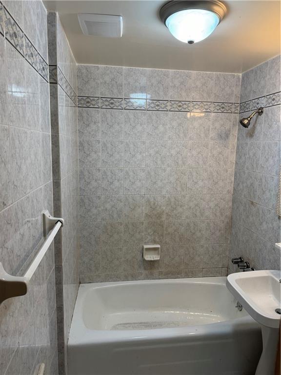 2069 East 55th Street Brooklyn, NY 11234 - Photo 3 of 6 a bathroom with a tub and a shower