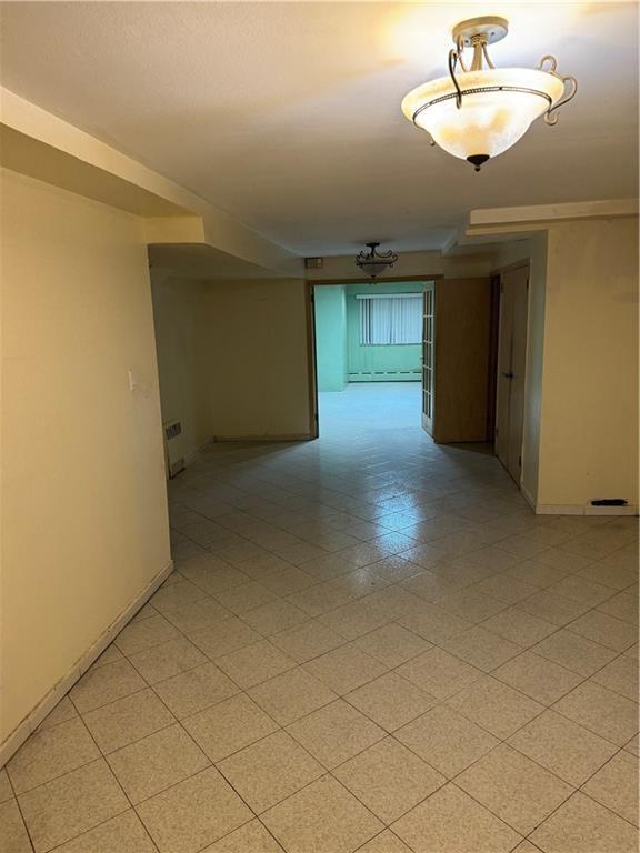 2069 East 55th Street Brooklyn, NY 11234 - Photo 5 of 6 a view of empty room and chandelier fan