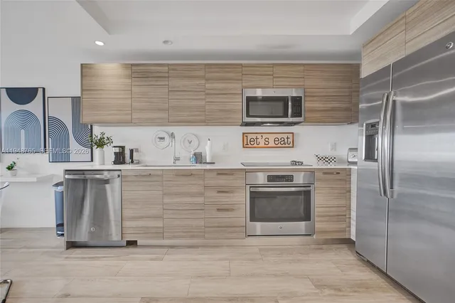 a kitchen with cabinets and stainless steel appliances