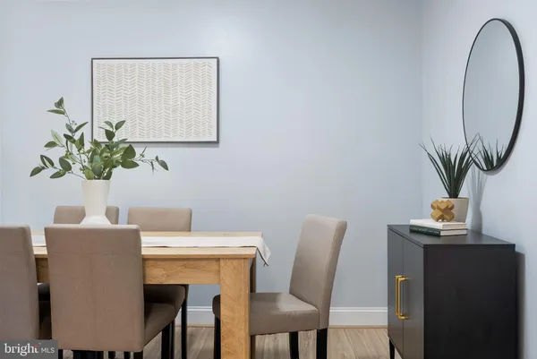a view of a dining room with furniture and a potted plant