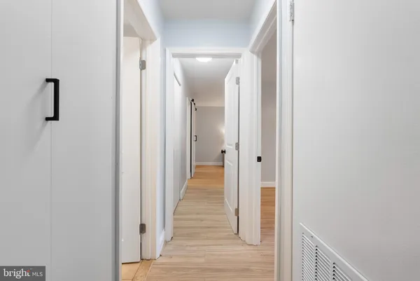 a view of a hallway with wooden floor