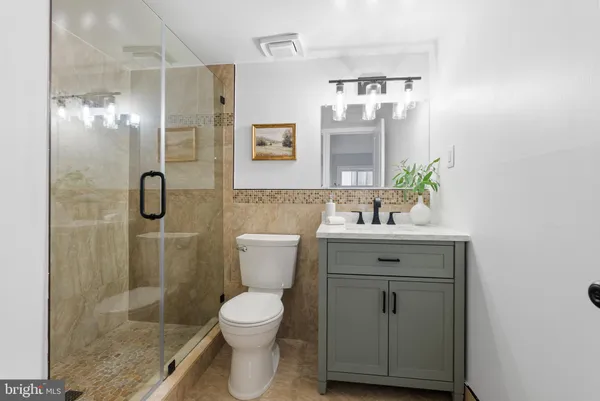 a bathroom with a sink toilet and shower