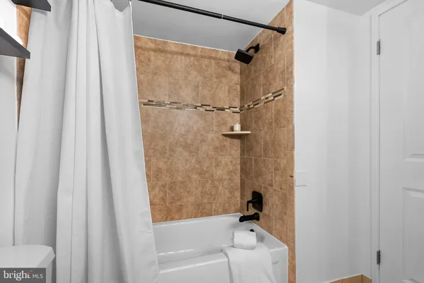 a bathroom with a shower and a bath tub