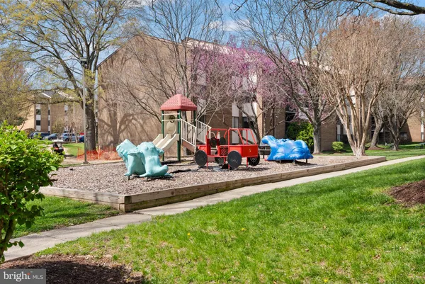a childrens park with lots of swings and slides