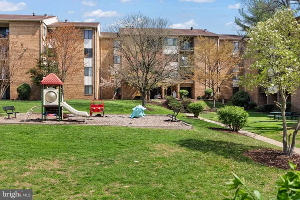 a view of a building with a yard and plants