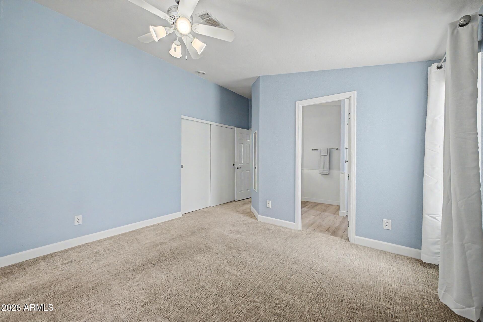 2550 South Ellsworth Road, Unit 50 Mesa, AZ 85209 - Photo 18 of 45 an empty room with fan and entrance