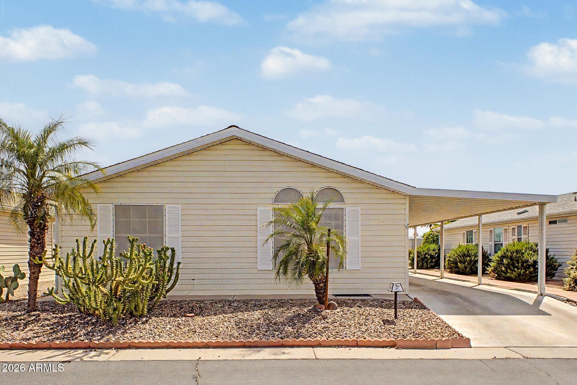 2550 South Ellsworth Road, Unit 50 Mesa, AZ 85209 - Photo 2 of 45 a front view of a house with garden