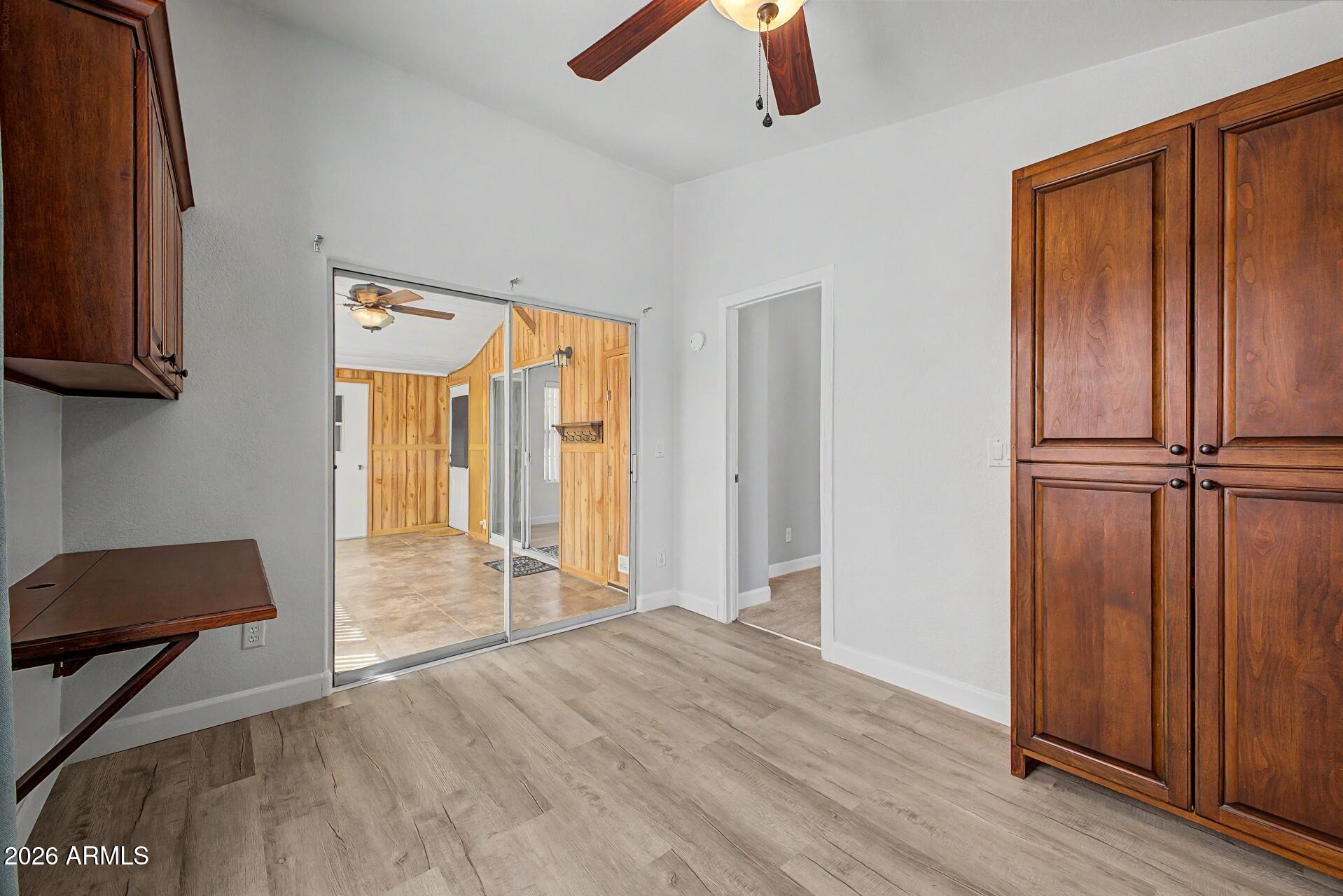2550 South Ellsworth Road, Unit 50 Mesa, AZ 85209 - Photo 22 of 45 an empty room with wooden floor closet and windows