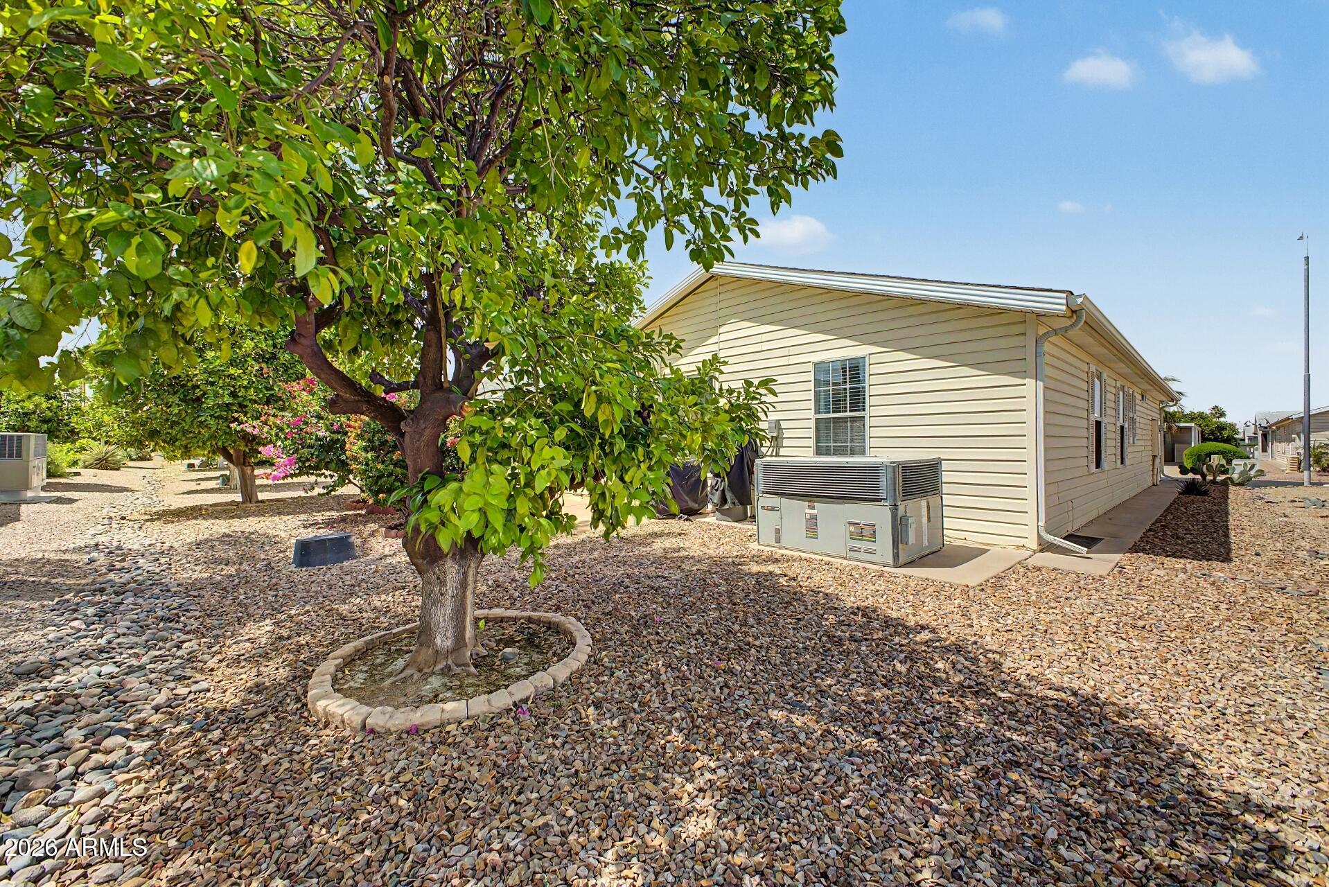 2550 South Ellsworth Road, Unit 50 Mesa, AZ 85209 - Photo 29 of 45 a front view of a house with garden