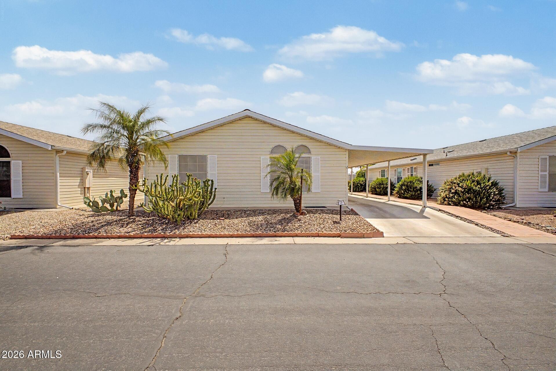 2550 South Ellsworth Road, Unit 50 Mesa, AZ 85209 - Photo 3 of 45 a front view of a house with a yard and garage