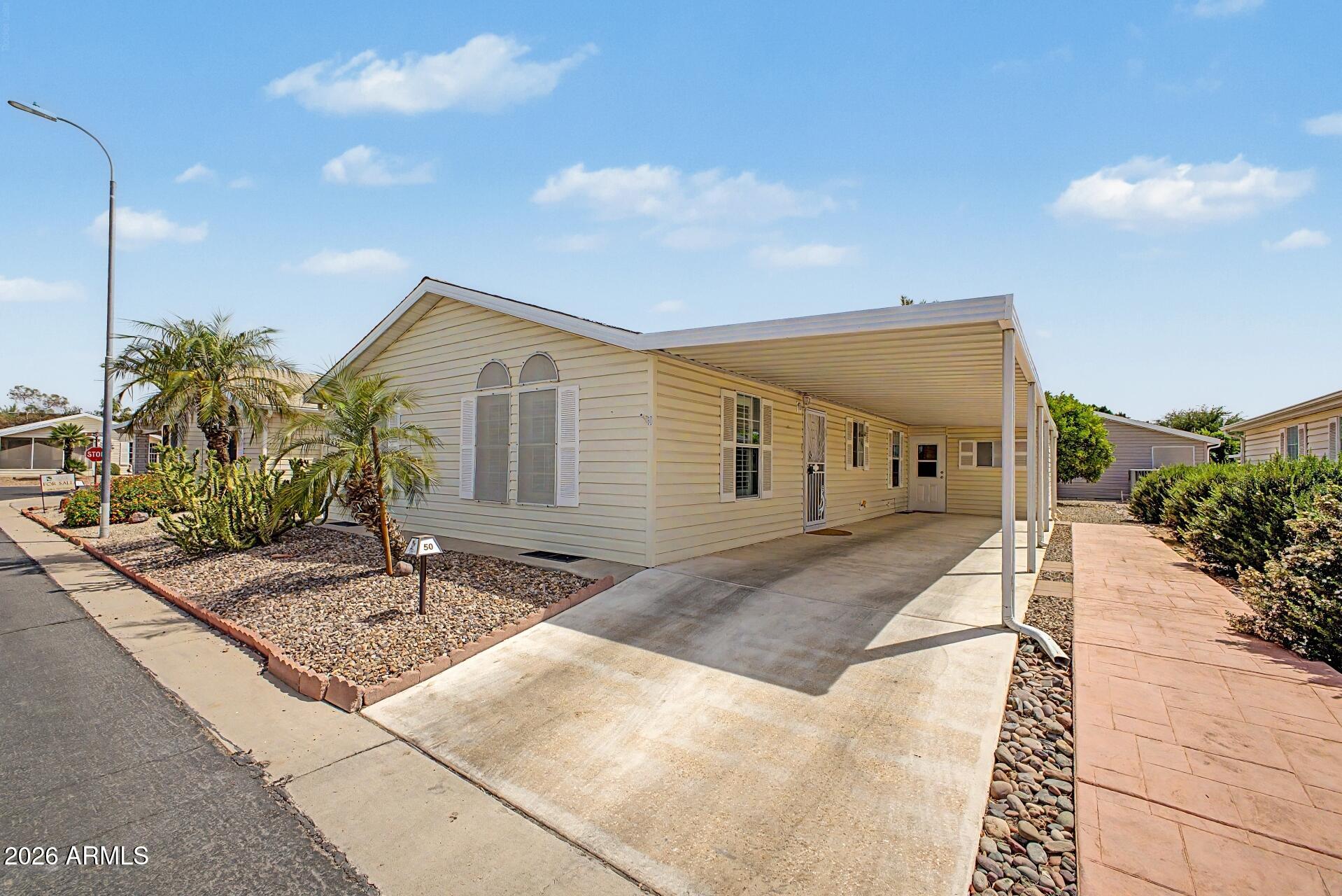 2550 South Ellsworth Road, Unit 50 Mesa, AZ 85209 - Photo 4 of 45 a front view of a house with garden