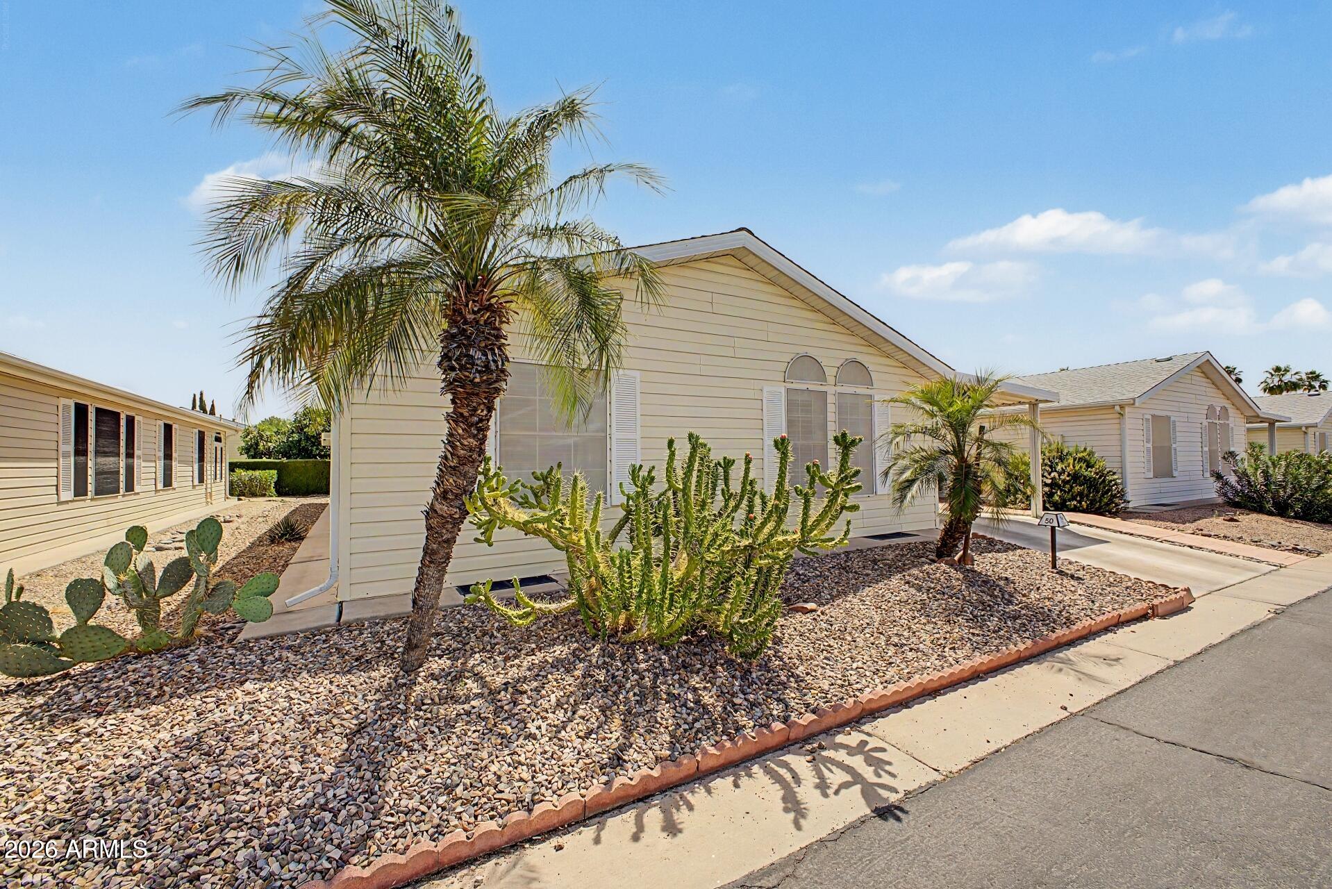 2550 South Ellsworth Road, Unit 50 Mesa, AZ 85209 - Photo 6 of 45 a front view of a house with garden